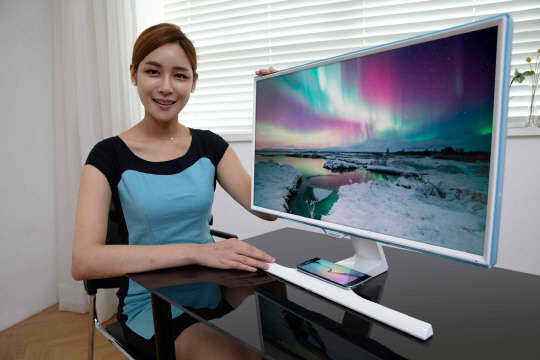 삼성전자가 27일 휴대폰 무선 충전이 가능한 24 형과 27 형 모니터 SE370을 출시한다고 밝혔다. SE370은 자기유도방식 무선충전 송신패드가 모니터 스탠드 부분에 내장되어 있어 사무공간을 깔끔하게 연출할 수 있고 PC 작업을 하다 휴대폰을 모니터 스탠드에 올려놓기만 해도 충전이 가능하다. 삼성전자 모델이 휴대폰 무선 충전이 가능한 모니터 SE370을 소개하고 있다.